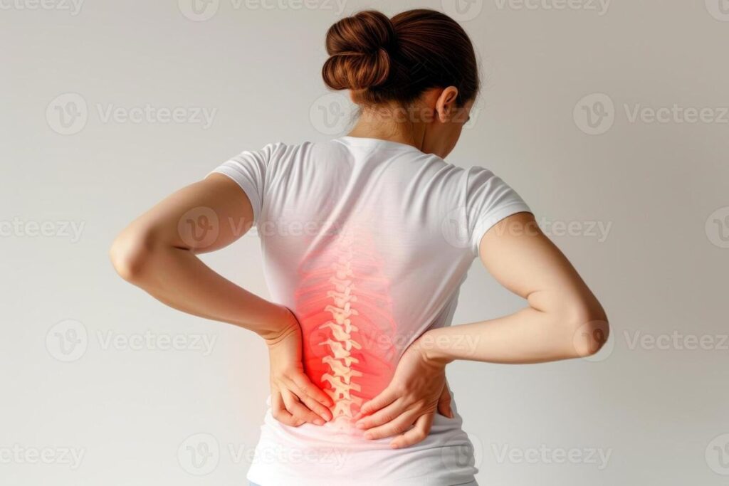 Person sitting with poor posture on laptop at home causing back and neck pain